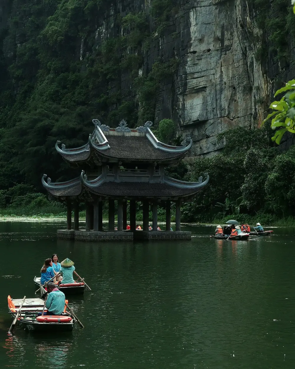 Thuyền chở khách trên sông giữa núi đá Ninh Bình